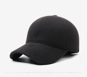 Detailed close-up of dark textured wool baseball cap featuring a metal SPORT S logo tag