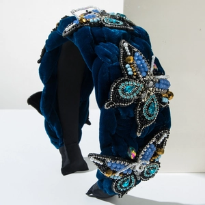 Detail of velvet braided headband featuring blue crystals and handmade pearl butterfly