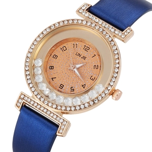 Detailed macro view of elegant ladies quartz watch with rhinestones and blue satin strap