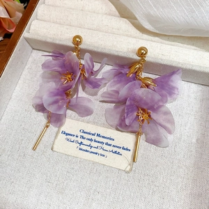 Elegant purple mesh flower dangle earrings with golden metal accents and pearlescent petals