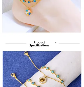 Detail of double-layer gold anklet with turquoise beads, clover and tree of life charms
