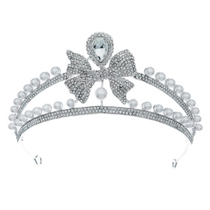 Detail of silver bridal crown featuring crystal bow design and teardrop rhinestone