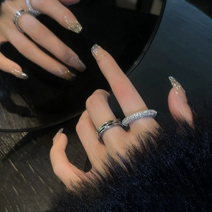 Close-up of a silver ring set with minimalist groove design and full pavé zircon stones