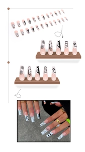 Detail of long coffin press-on nails featuring black and white graffiti floral designs