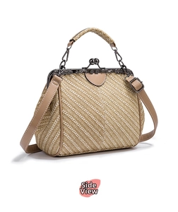 Detail of vintage doctor bag with herringbone straw weave and antique silver carved clasp