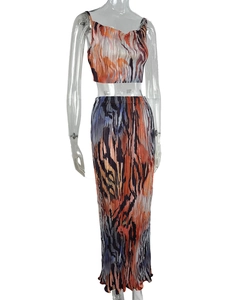 Detailed close-up of pleated fabric texture with abstract art print in orange and blue