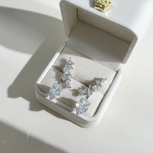Macro shot of silver drop earrings with marquise and teardrop cubic zirconia in a jewelry box