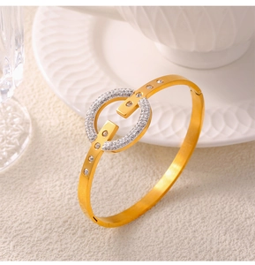 Detailed view of hollow gold bracelet with layered pavé diamonds and circular center