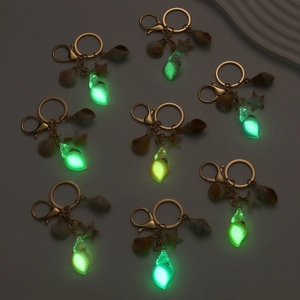 Luminous shell keychain set with glowing green starfish and conch beach charms