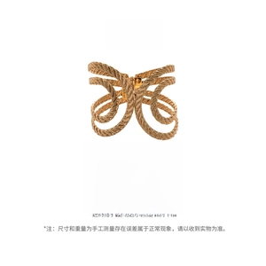 Detailed view of wide gold-colored open cuff bracelet with woven texture and dimensions