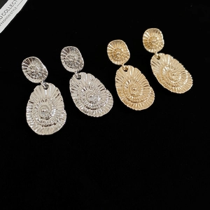 Macro shot of gold and silver vintage spiral earrings with textured shell design