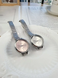 Chic women's metal chain quartz watches with pink and silver dials on ceramic plate