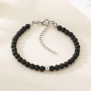Detail view of black lava stone beaded bracelet with adjustable steel lobster clasp