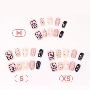 Pink glitter star press-on nails with leopard print and rhinestone accents in sizes XS S M