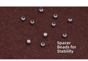 Macro shot of silver metal spacer beads for jewelry making on felt background