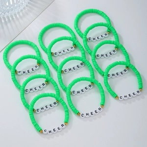 Detail of 12 bright green clay bead bracelets with CHEER letter beads and gold spacers