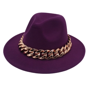 Detail of dark purple fedora hat with a chunky rose gold metal chain decoration