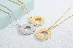 Detailed shot of three gold and silver heart-engraved MOM necklaces with zircon borders