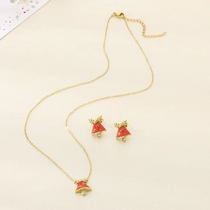 Detail view of gold Christmas tree jewelry set with red enamel and small crystals