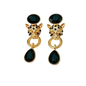 Vintage leopard head drop earrings with black crystals and gold finish on white background