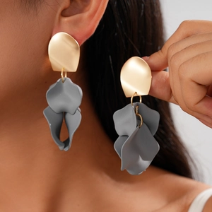 Chic acrylic irregular pleated flower earrings with gold metal top worn by a model