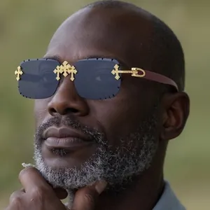 Close-up of rimless oversized polarized sunglasses with golden cross metal decoration