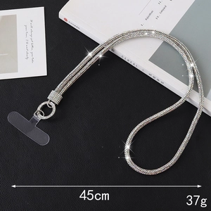 Luxury silver rhinestone phone lanyard with transparent connector on leather background