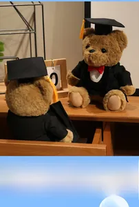 Detailed view of graduation teddy bears in academic gowns on a warm wooden table