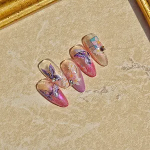 Detailed view of handmade stiletto nails with purple butterfly and floral nail art designs