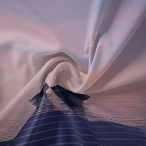 Macro detail of the lightweight chiffon fabric showing smooth drape and sunset print