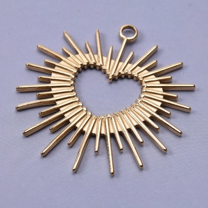 Macro shot of 18k gold plated 304 stainless steel heart sunburst pendant with top loop