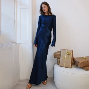 Detail of dark blue satin evening gown featuring elegant backless slit and long sleeves
