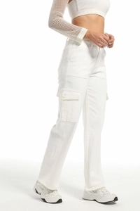 Detail of white high-waisted cargo pants featuring a large functional side flap pocket