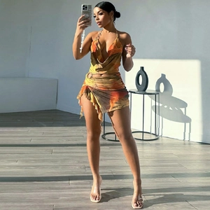 Detail of a mesh two-piece set featuring abstract print, halter neck and side drawstring
