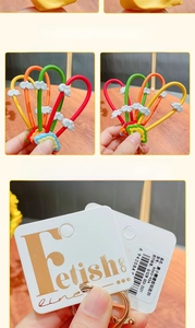 Detail of colorful PVC wrist straps with 3D cloud charms and gold metal keyrings