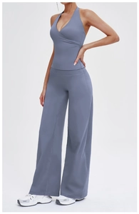Detail of cross halter neck top and high-waist wide-leg yoga pants in dusty blue