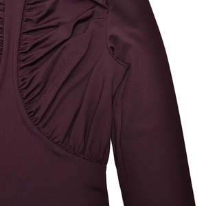 Detail of elegant pleated neckline and shoulder seam on dark purple long sleeve dress