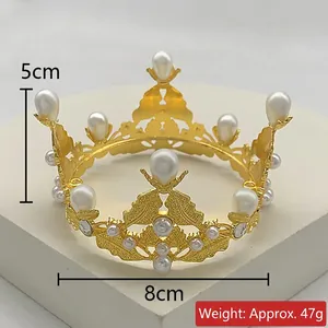Detailed view of mini golden alloy crown with white pearls, size 8cm diameter and 5cm height