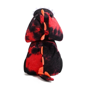 Detail of red and black tie-dye plush dinosaur backpack with orange spikes and tail