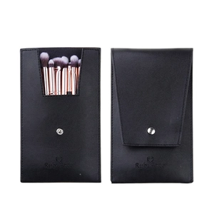 Detail of portable black PU leather makeup brush set with rose gold metal handles