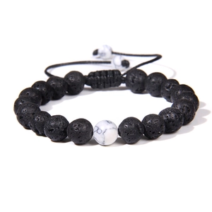 Detail of adjustable lava stone bracelet with white turquoise bead and braided rope