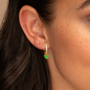 Close-up of gold S925 silver hoop earrings with green heart charms and zircon stones