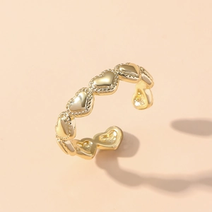 Adjustable gold heart ring featuring a continuous textured peach heart pattern for women