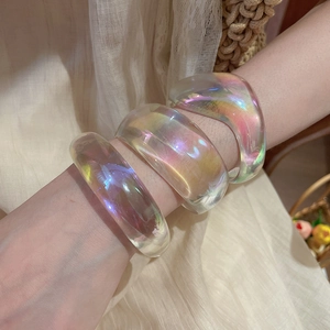 Iridescent acrylic geometric bangles set with rainbow color effect shown on wrist