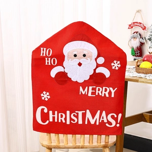 Detail of red Christmas chair cover with HO HO lettering on a wooden chair back