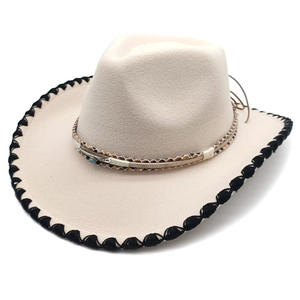 Detail of western fedora brim with black whipstitch and turquoise feather accent