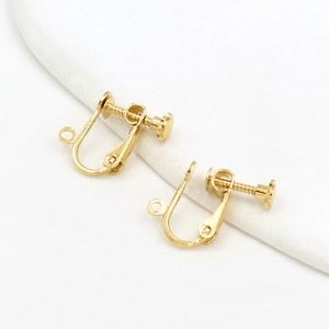 Macro view of gold plated screw-on earring converters for non-pierced ears