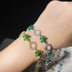 Detailed close-up of zircon flower bracelet on wrist featuring gold and silver floral links