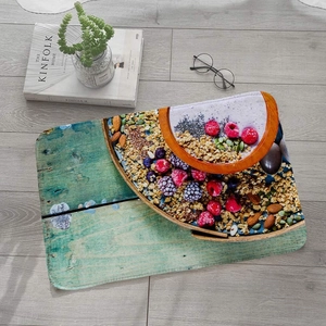 Flat lay of a fruit pattern flannel bath mat with berries and wood grain on grey floor