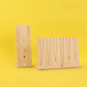 Solid wood necklace display stands with natural grain on a bright yellow background